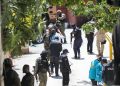Police officers and a forensics team looking for evidence outside the presidential residence near Port-au-Prince, Haiti, on Wednesday.