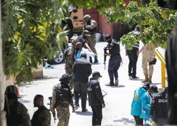 Police officers and a forensics team looking for evidence outside the presidential residence near Port-au-Prince, Haiti, on Wednesday.