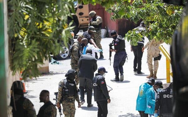 Police officers and a forensics team looking for evidence outside the presidential residence near Port-au-Prince, Haiti, on Wednesday.
