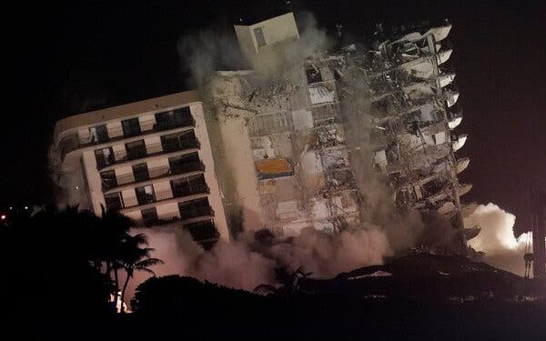 The part of the Champlain Towers South condominium building that was still standing was demolished late Sunday in Surfside, Fla.