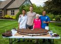 From left to right: Chef Roddy Martin, social media influencers Ross Smith and Gangster Granny and chef Stephen Miller pose with the 180-pound Oreo cookie they baked together in Ohio.