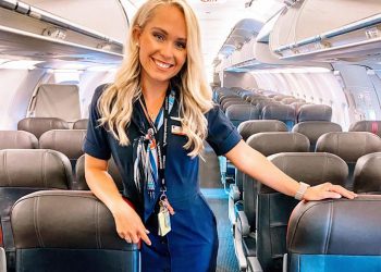 Caroline Skahn in her flight attendant uniform on a plane