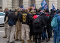 A group of men, some of whom are wearing "Oath Keepers" insignia, gathers as rioters storm the U.S. Capitol in Washington on Jan. 6.