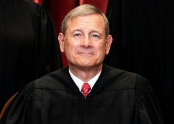 Chief Justice John Roberts sits during a group photo of the justices at the Supreme Court in Washington, D.C., on April 23, 2021. The justice has battled seizures.