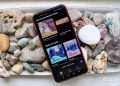 Spotify menu on a smartphone on a bed of rocks
