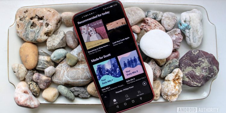 Spotify menu on a smartphone on a bed of rocks