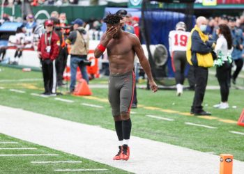 Tampa Bay Buccaneers wide receiver Antonio Brown wipes his face as he leaves the field after throwing his equipment into the stands while his team is on offense during the third quarter of an NFL football game against the New York Jets, Sunday, Jan. 2, 2022, in East Rutherford, N.J. (Andrew Mills/NJ Advance Media via AP)