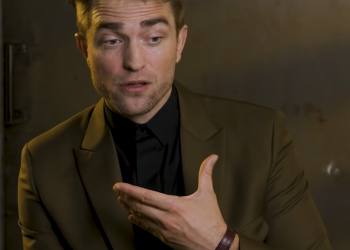 Image may contain Robert Pattinson Clothing Suit Overcoat Apparel Coat Human and Person