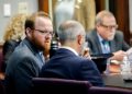 Travis McMichael, left, speaks with his attorney, Jason Sheffield, center, during the sentencing hearing for the murder of Ahmaud Arbery. Travis, his father, Gregory, right, and William "Roddie" Bryan were sentenced to life in prison Jan. 7 at the Glynn County Courthouse in Brunswick, Ga.