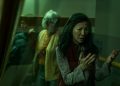 Michelle Yeoh looks at her hands as Jamie Lee Curtis raises a fist in "Everything Everywhere All At Once."