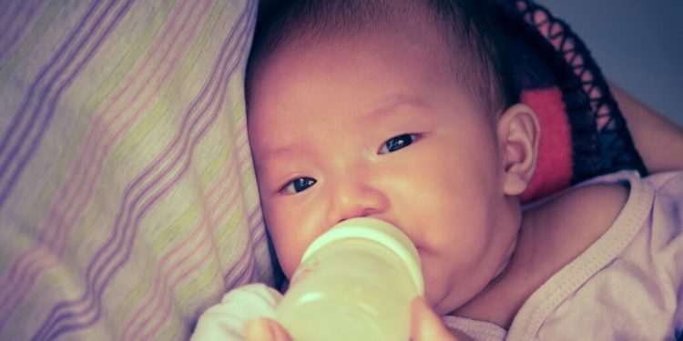 Baby drinking milk on mother's chest