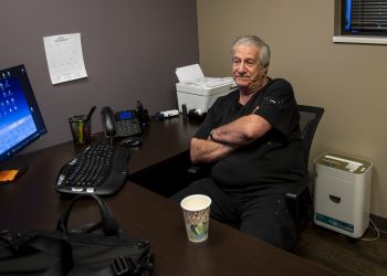 Man sits in his office.