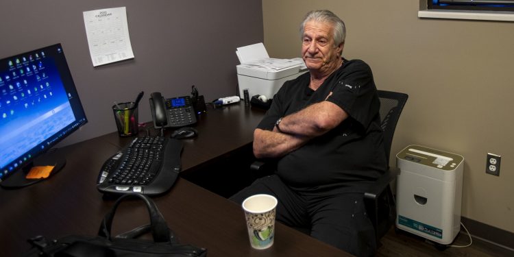 Man sits in his office.