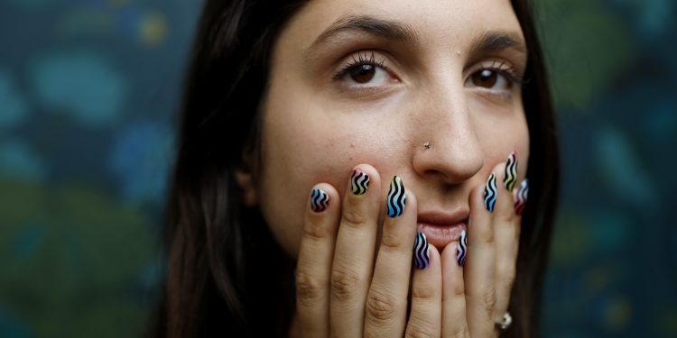 A woman shows off her manicure.