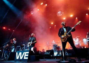 A rock band performs onstage