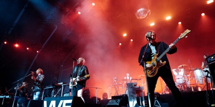 A rock band performs onstage