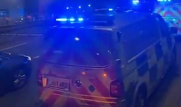 Police were called at 3.48am to the crash on the A40 near Park Royal underground station after the Range Rover ended up on the railway track. Pictured: Met Police at the scene