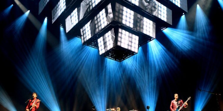 A band performs on a large stage