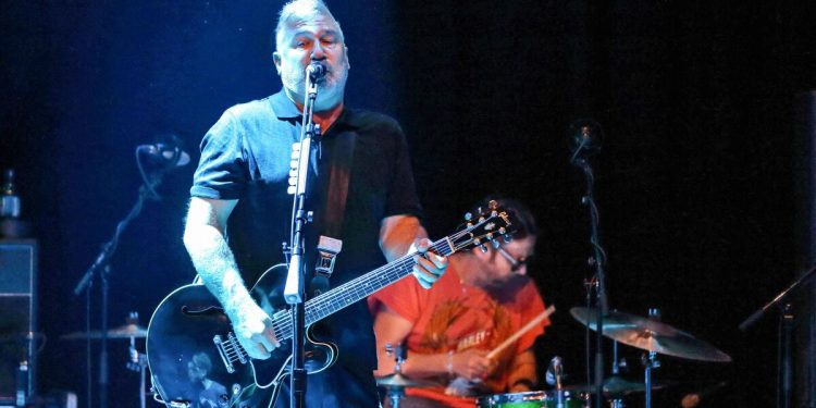 A rock guitarist/singer and drummer performing onstage