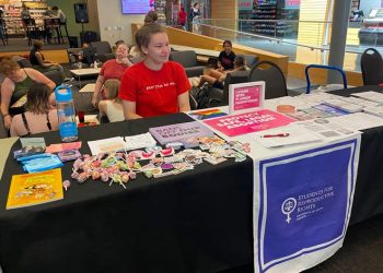 Anna Bottesini sits in the University of South Dakota student center ready to answer questions about abortion access and share resources with her fellow students.