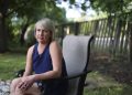Christine Settingsgaard sits in her yard on Wednesday, Sept 14, 2022, in Barrington. Settingsgaard was lured into sophisticated financial scam this summer via a man she met on Hinge, and “lost everything.”